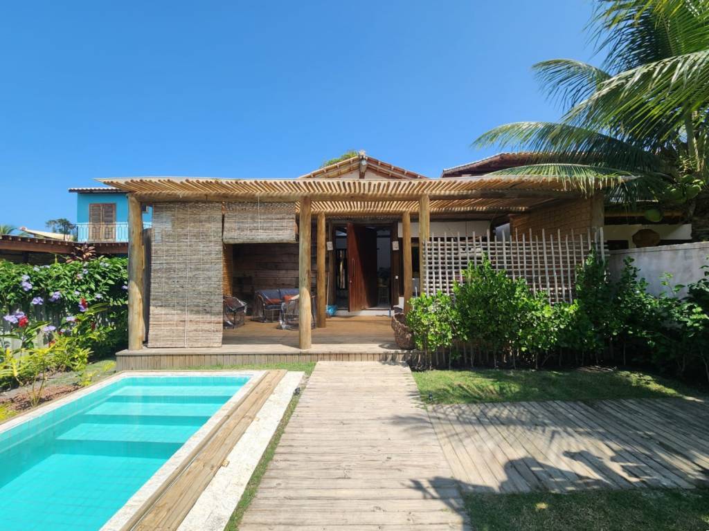 Casa pátio de praia na Bahia foi erguida em torno das árvores. Projeto de Mari Grobério. Na foto, fachada, piscina.