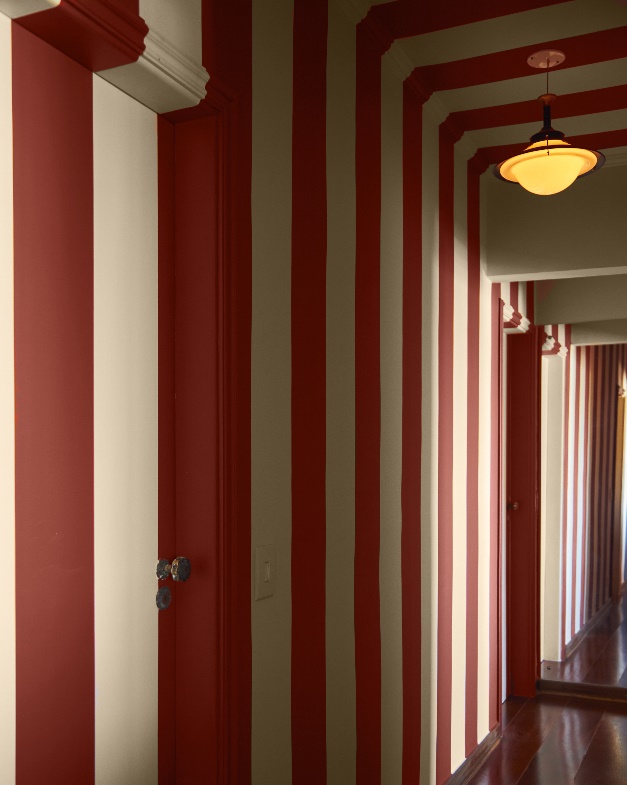Decorações assustadoras! Veja projetos com cores inspiradas no Halloween. Na foto, corredor listrado vermelho e branco.