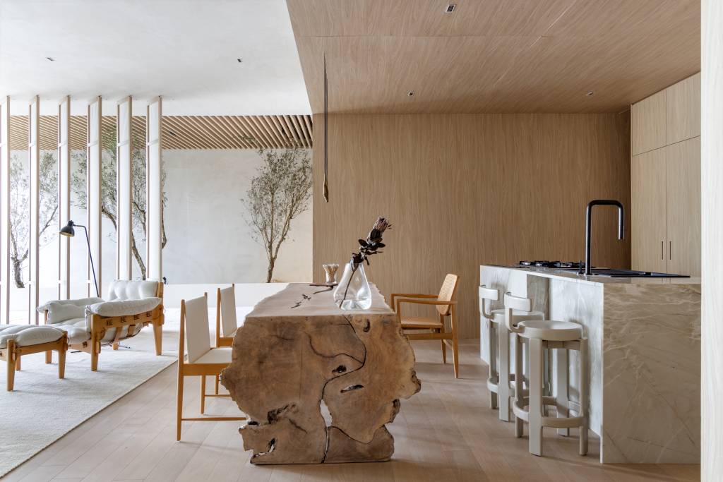 Loft reflete sobre o tempo com a presença de árvores, pedras e texturas naturais. Projeto de Mariana Maisonnave para a CASACOR SC 2024.