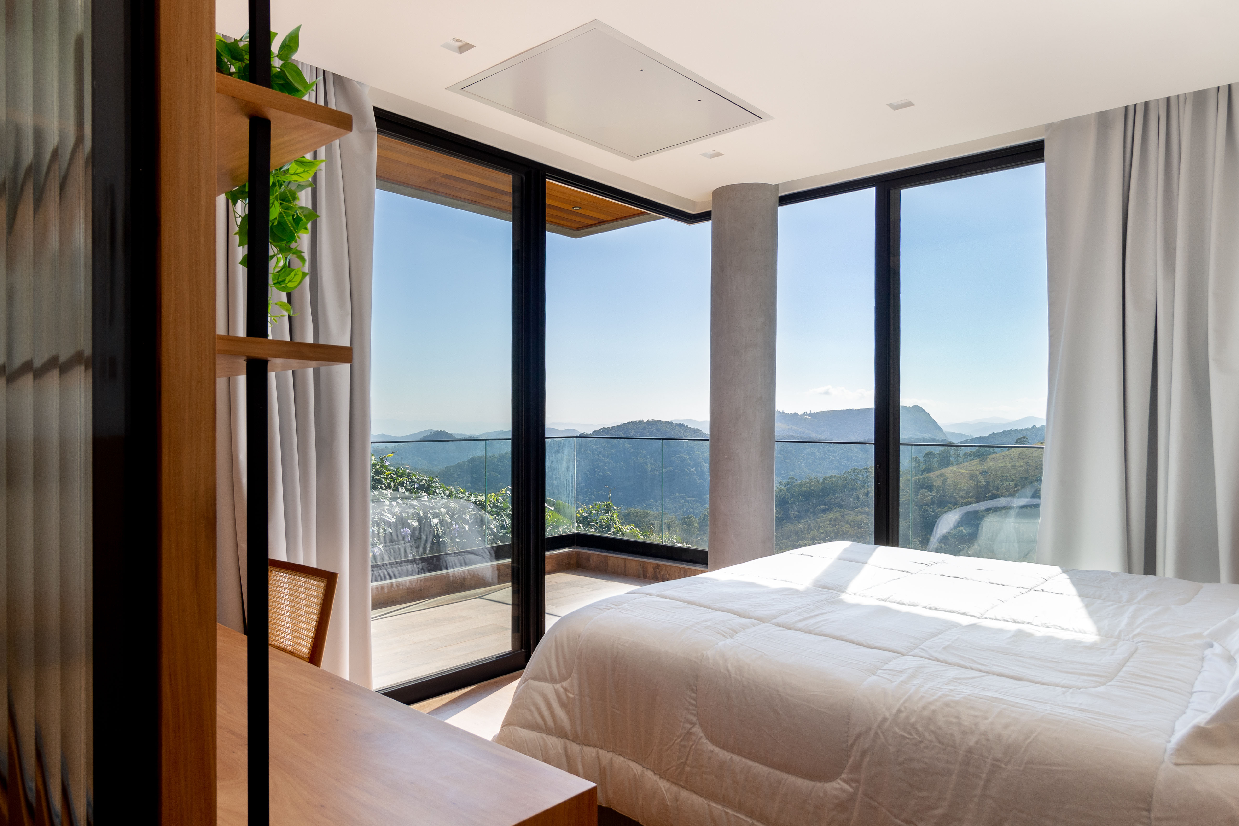 Casa de 720 m² fica no topo de uma montanha no RJ. Projeto de Rafael Ramos. Na foto, quarto com vista para as montanhas.