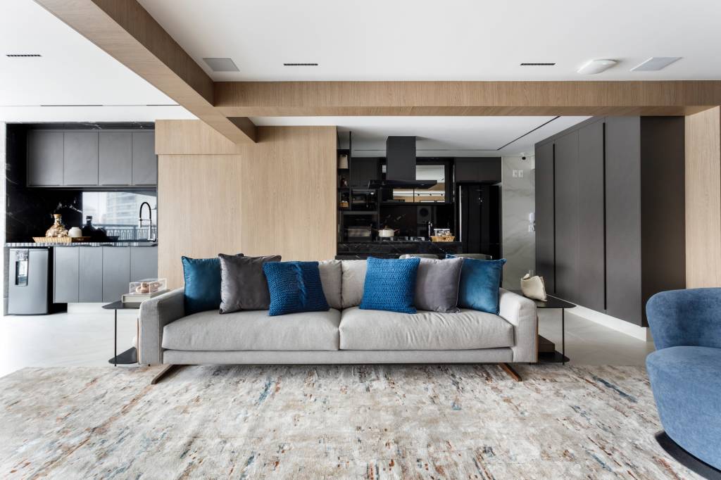 Apê de 147 m² tem dois escritórios — um deles na varanda! Projeto de Aline Lopes. Living com sofá cinza.