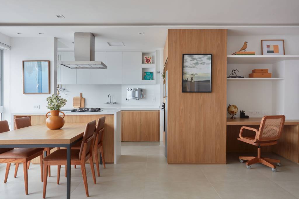 Apê de 50 m² tem portas de correr e bancada de trabalho na estante. Projeto de Carolina Gouvea Arquitetura. Na foto, sala de jantar.