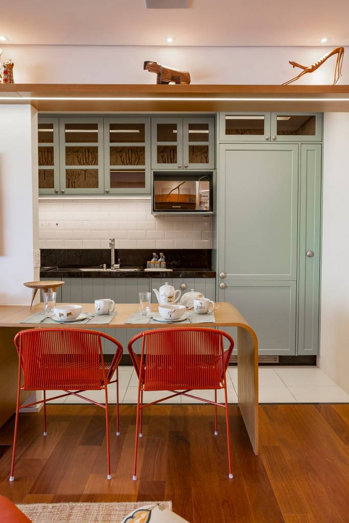 Paleta de cores vibrantes e brasilidade dão cara de casa à apê de 98 m². Projeto de Patrícia Viegas. Na foto, cozinha integrada, marcenaria verde clara.