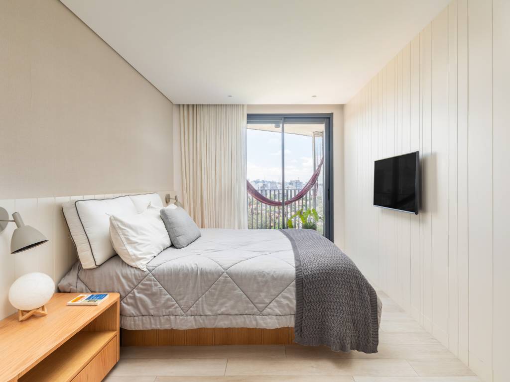 Minimalismo com pontos de cor: conheça este apê relaxante na Vila Madalena. Projeto de André Ávila Arquitetura. Na foto, quarto com rede na varanda.