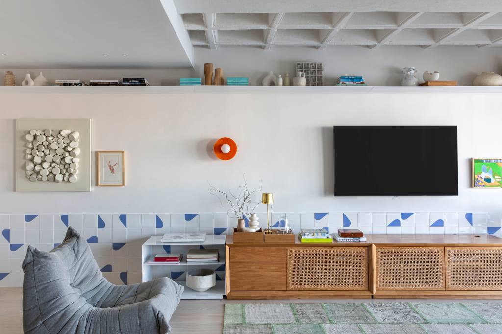 Cortina funciona como divisória em apartamento de 85 m² que tem home office com vista. Projeto de Pipa Arquitetura.
