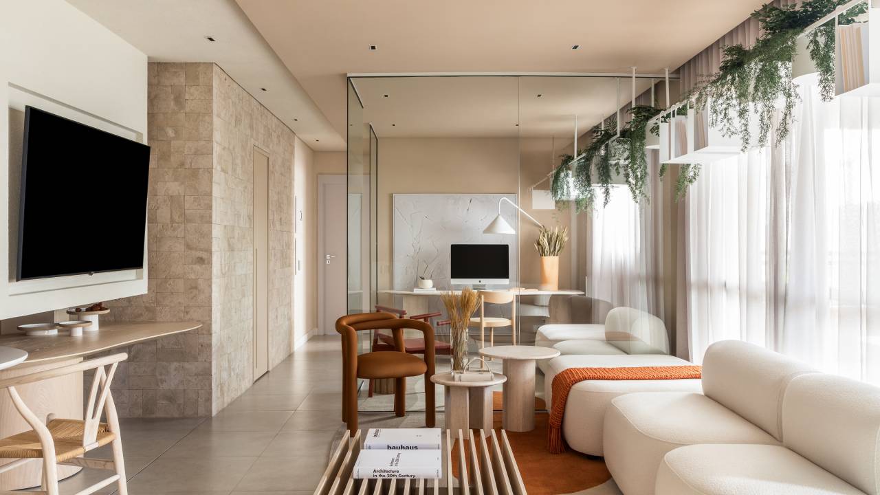 Apartamento tem prateleiras suspensas com jardineiras para plantas pendentes. Projeto de Bohrer Arquitetos.
