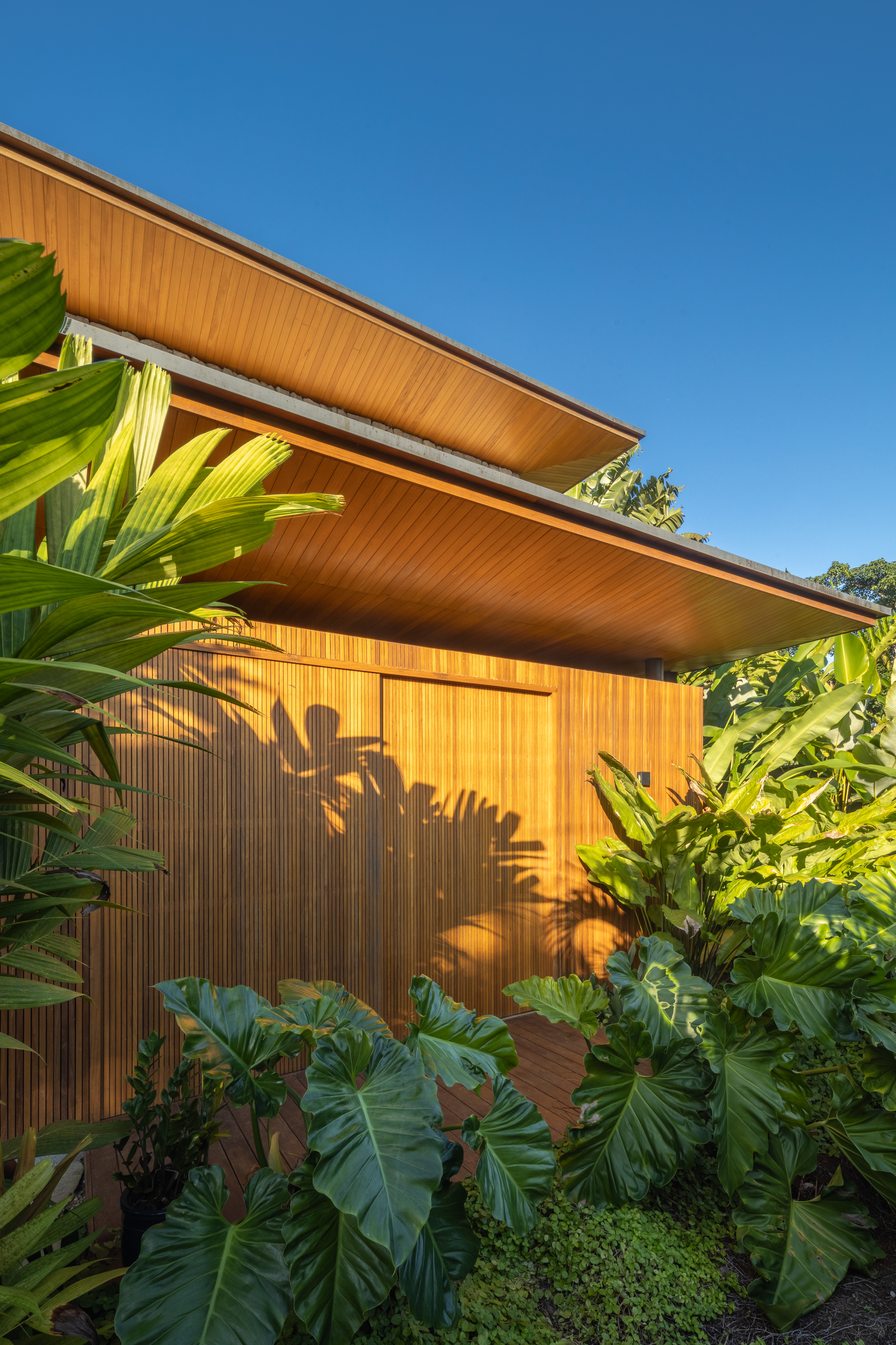 Cobertura com beirais chanfrados dá leveza a esta casa com 5 suítes. Projeto de Pitta Arquitetura.