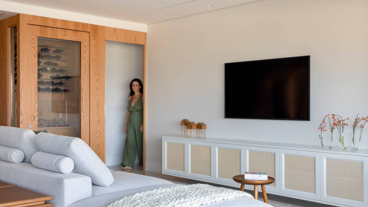 Apartamento tem adega para 200 garrafas com revestimento em folha de carvalho. Projeto de Beta Arquitetura.