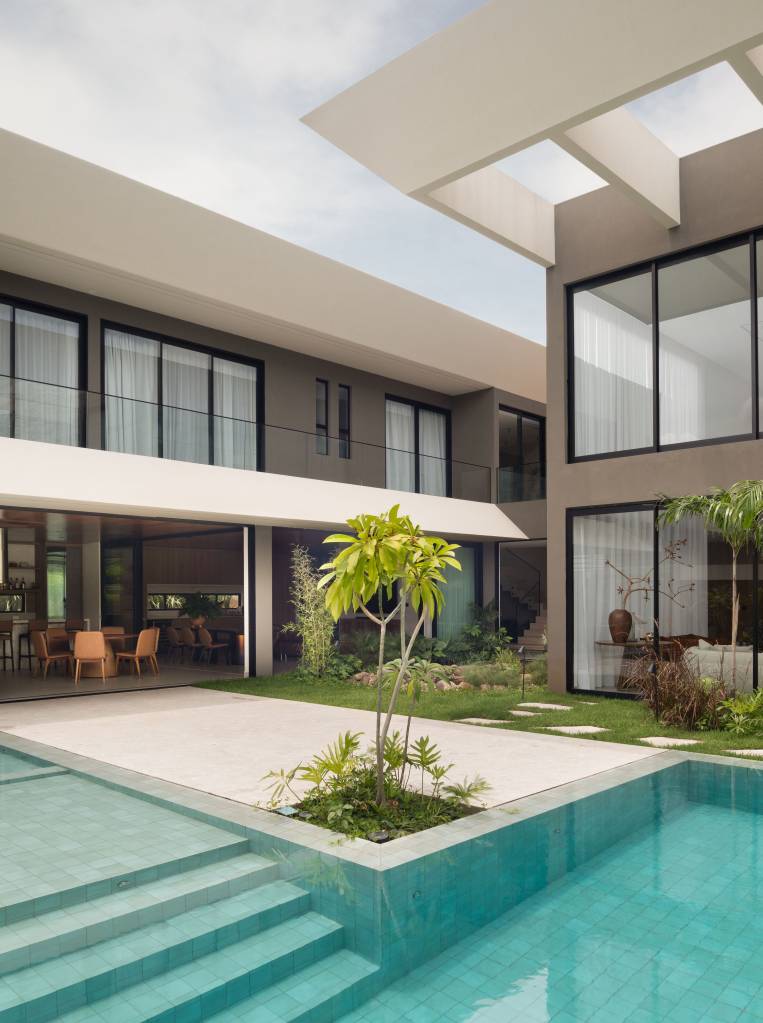 casa-elegante-tem-fachada-com-lastras-de-porcelanato-e-jardim-com-lago-artificial-dois-arquitetura-01 Casa elegante tem fachada com lastras de porcelanato e jardim com lago artificial. Projeto de Dois Arquitetura.