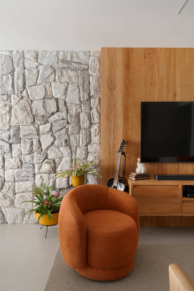 Parede de pedras na sala é ponto de partida deste apartamento elegante de 80 m². Projeto de Júlia Santana.