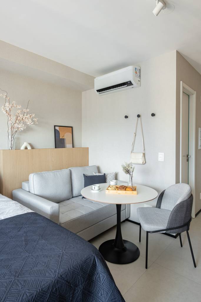 Miniapartamento de 24 m² tem sofá-cama e cozinha linear completa. Projeto de VilaVille Arquitetura.