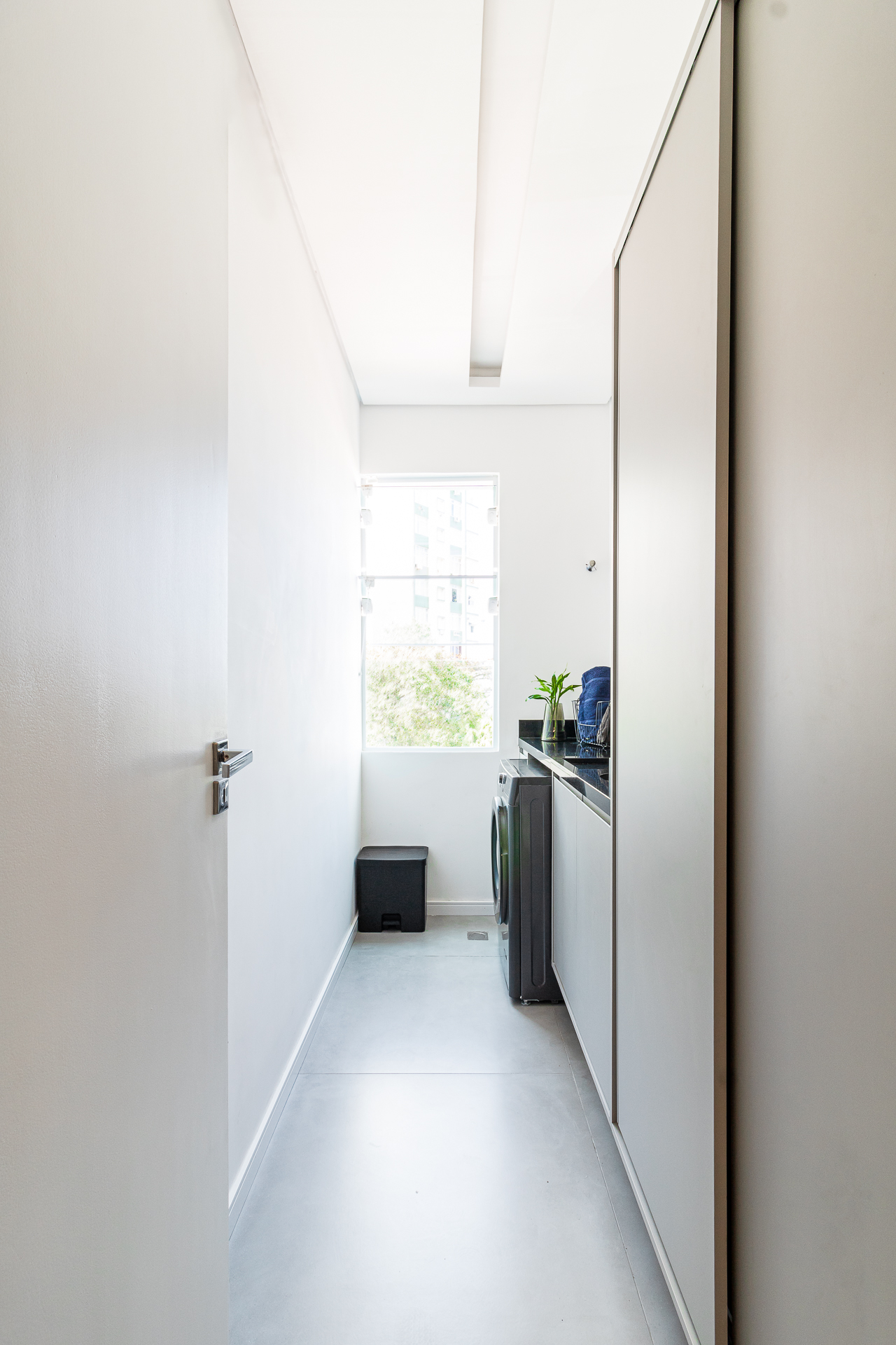 Kitnet de 33m² ganha área de serviço e cozinha integrada à sala após reforma. Projeto de Bimá Arquitetura. Área de serviço.